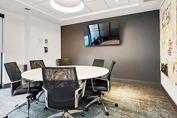 A conference room with a white table and chairs at Circ Apartments, Richmond, Virginia